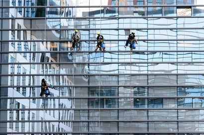 Window cleaners with their supplies at work at a office building.