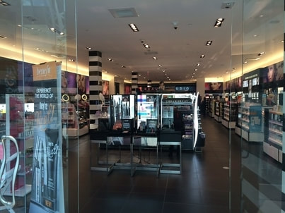 Picture of an retail store with open glass doors.