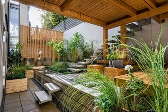 Nicely looking terrace with a lot of plants, streak free windows, and a well functioning gutter.
